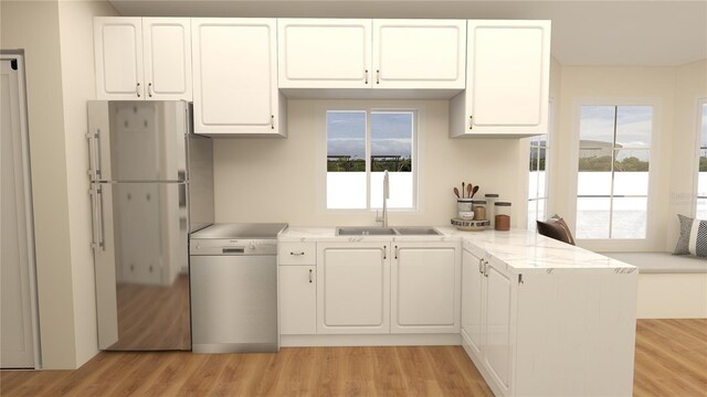 kitchen featuring white cabinetry, light hardwood / wood-style flooring, kitchen peninsula, sink, and white refrigerator