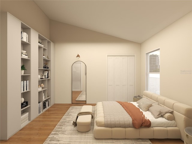 bedroom with lofted ceiling, hardwood / wood-style floors, and a closet