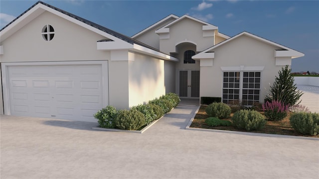 ranch-style house with concrete driveway, an attached garage, french doors, and stucco siding