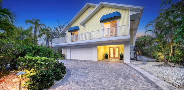 view of front of home featuring french doors and a balcony