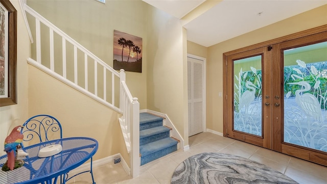 tiled entryway featuring french doors