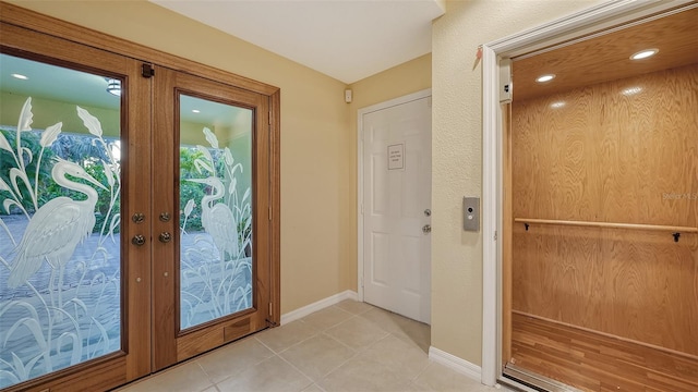 doorway featuring french doors, elevator, and light tile floors