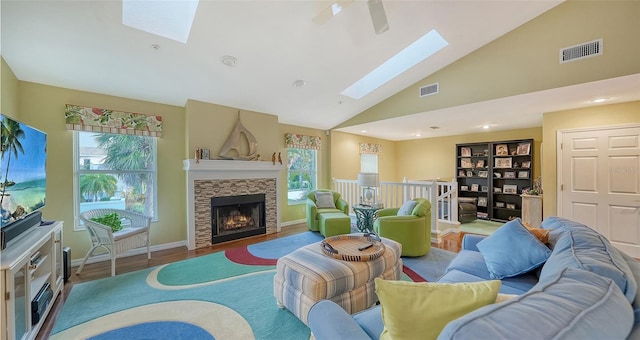 living room featuring a skylight, light wood-type flooring, and a wealth of natural light