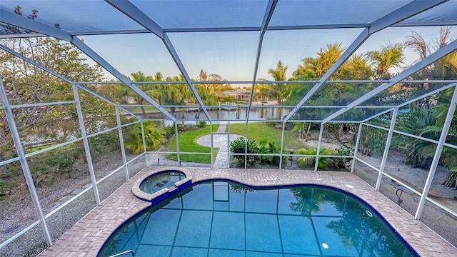 view of pool featuring a lanai, an in ground hot tub, and a patio area