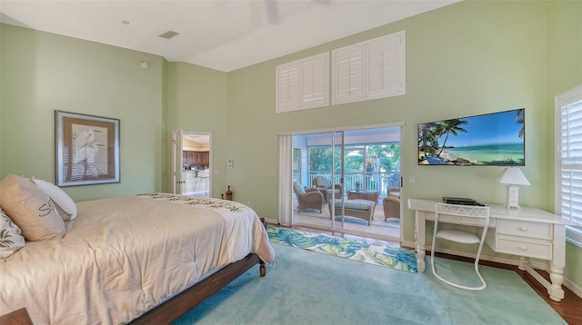 bedroom featuring access to outside and a high ceiling