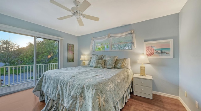 bedroom with dark hardwood / wood-style flooring, ceiling fan, and access to exterior