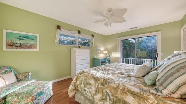 bedroom with dark hardwood / wood-style flooring, ceiling fan, and access to outside