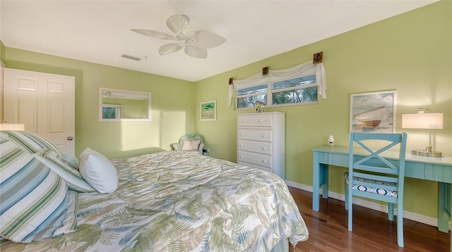 bedroom with dark hardwood / wood-style floors and ceiling fan