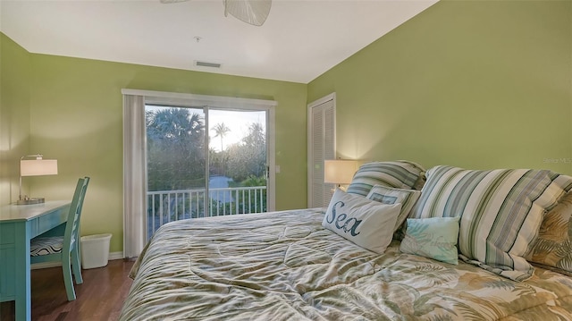 bedroom with a closet, ceiling fan, access to exterior, lofted ceiling, and dark hardwood / wood-style floors