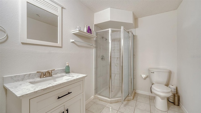 bathroom with a shower with shower door, toilet, vanity, and a textured ceiling