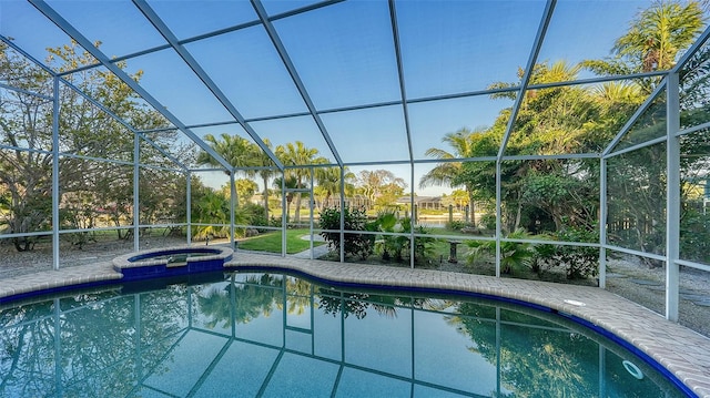 view of pool featuring a patio area, an in ground hot tub, and a lanai