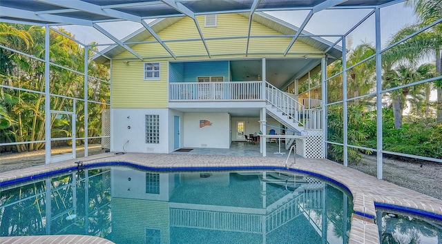 view of swimming pool with a lanai and a patio