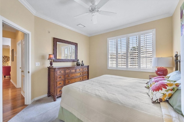 bedroom featuring crown molding, ceiling fan, and carpet