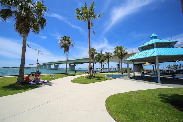 view of home's community featuring a water view and a lawn