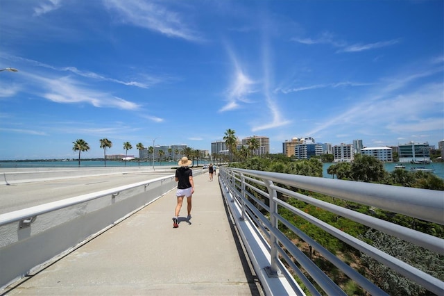 view of property's community featuring a beach view and a water view