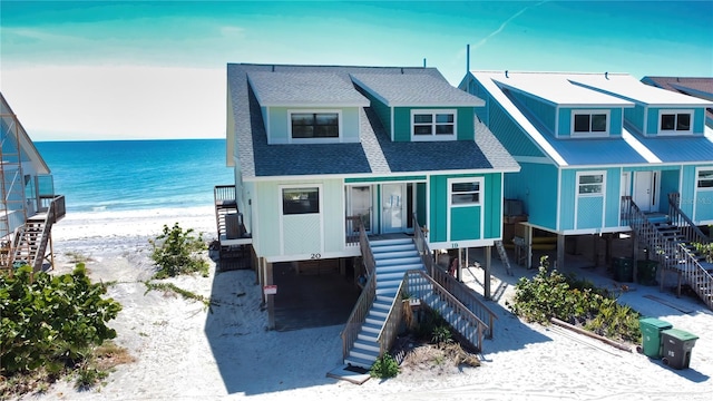 view of front of property with a water view and a porch