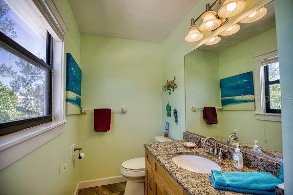 bathroom with vanity with extensive cabinet space and toilet