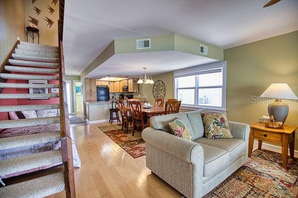 living room featuring a chandelier and light wood-type flooring