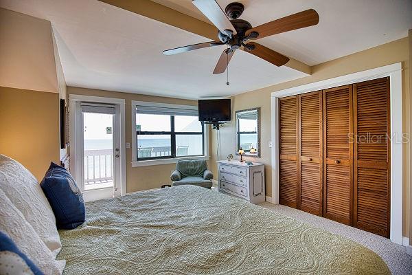 bedroom featuring a closet, carpet floors, ceiling fan, and access to outside