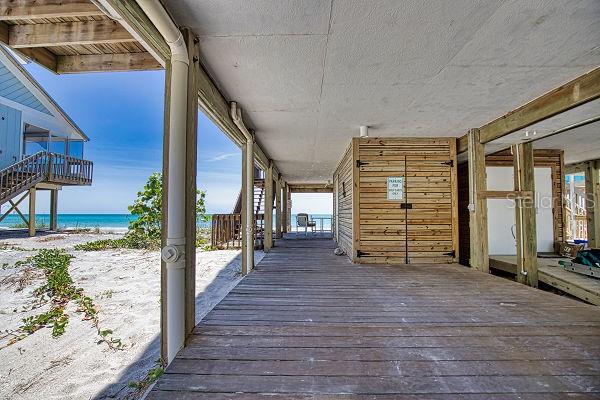 wooden terrace featuring a water view