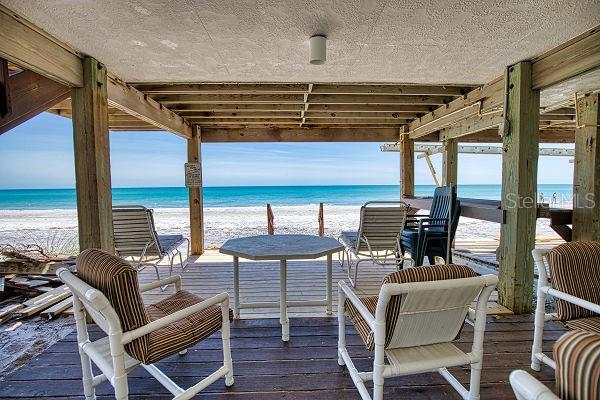 exterior space with a water view and a view of the beach