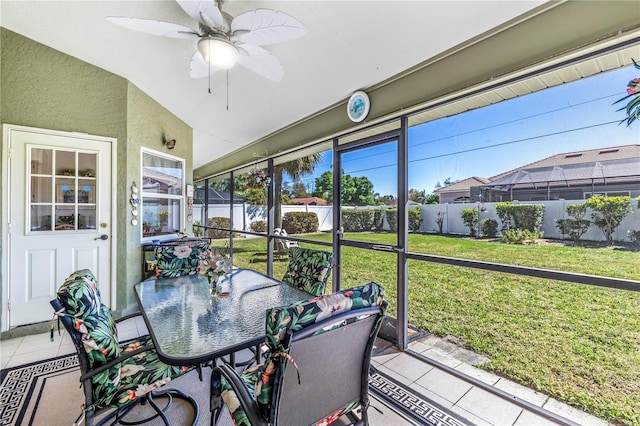 sunroom / solarium featuring ceiling fan