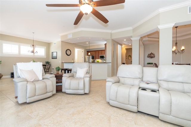 tiled living room with ceiling fan with notable chandelier, ornate columns, and crown molding