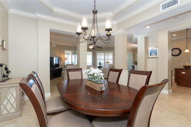 tiled dining room featuring ceiling fan with notable chandelier, crown molding, and a raised ceiling