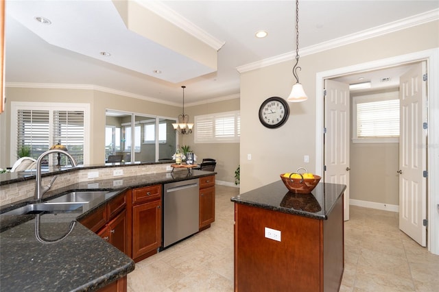 kitchen featuring a wealth of natural light, a center island with sink, decorative light fixtures, and stainless steel dishwasher