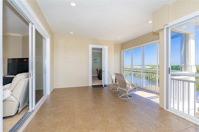 sunroom / solarium featuring a water view