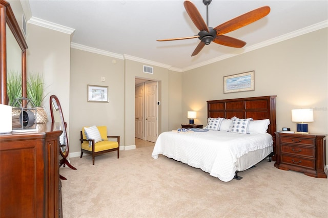 carpeted bedroom featuring ornamental molding and ceiling fan