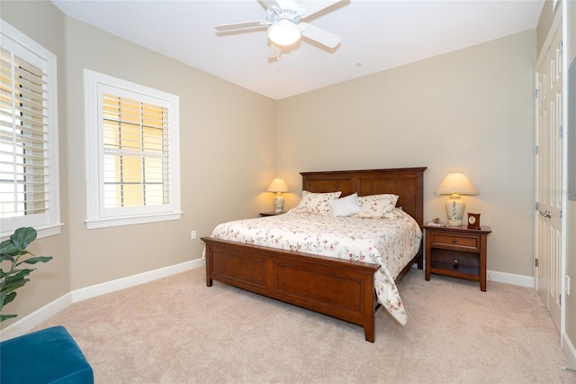 bedroom featuring light colored carpet and ceiling fan