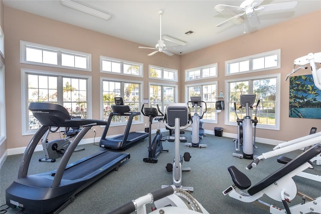 workout area with ceiling fan and carpet flooring