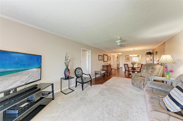 carpeted living room with crown molding, a textured ceiling, and ceiling fan with notable chandelier