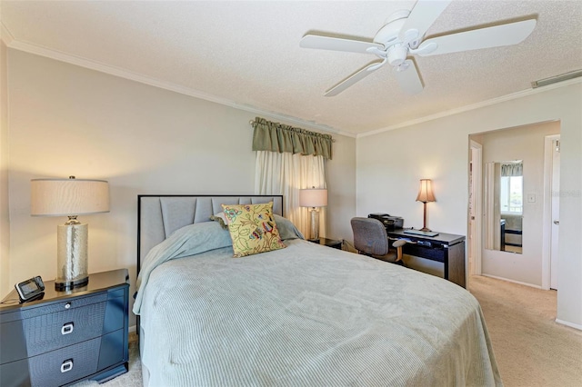 carpeted bedroom featuring ornamental molding, a textured ceiling, and ceiling fan