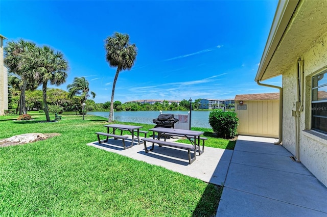 view of yard with a water view and a patio area