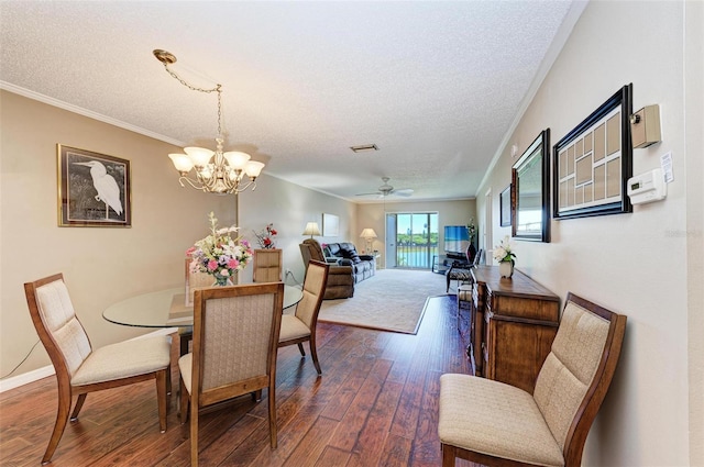 dining room featuring crown molding, a textured ceiling, ceiling fan with notable chandelier, and dark hardwood / wood-style flooring