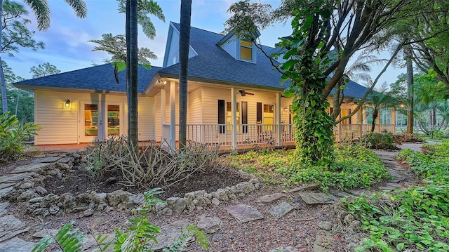 rear view of property featuring covered porch