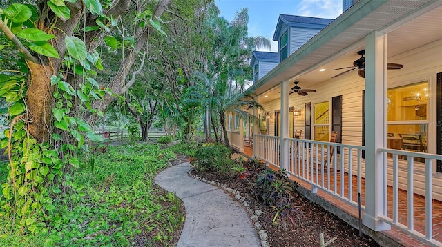 view of yard with ceiling fan and a porch