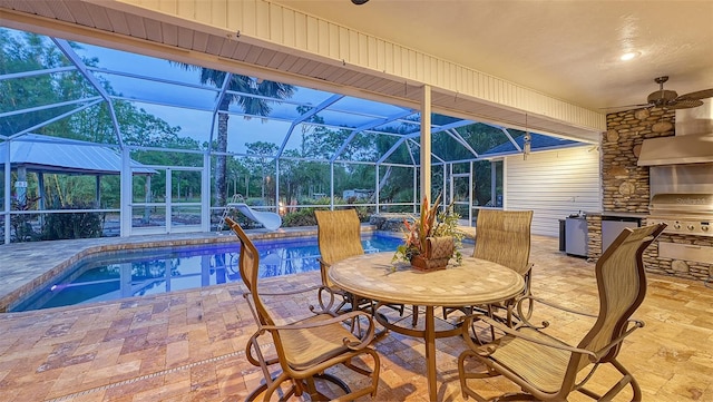 pool at dusk with a patio area, ceiling fan, area for grilling, and a lanai