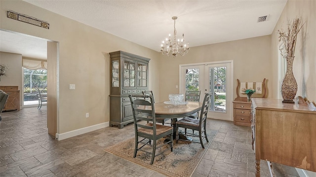 dining space with french doors, a chandelier, light tile floors, and a wealth of natural light