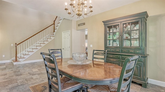 tiled dining space featuring a chandelier