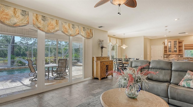 tiled living room featuring ceiling fan