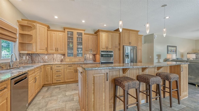 kitchen featuring backsplash, appliances with stainless steel finishes, sink, and light stone countertops