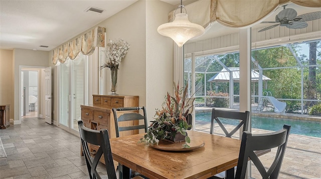 dining area with ceiling fan and light tile floors