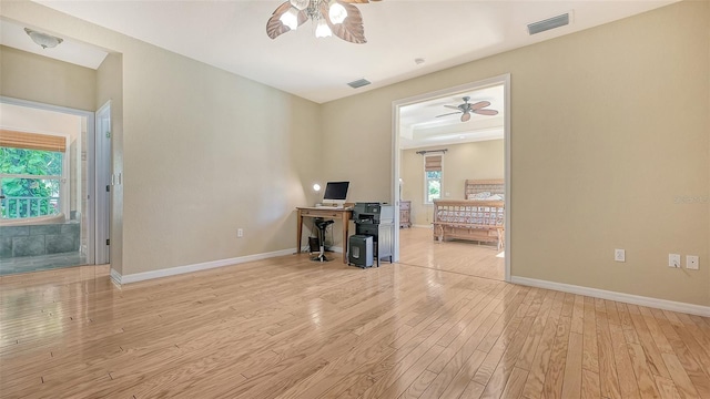 spare room with ceiling fan and light wood-type flooring