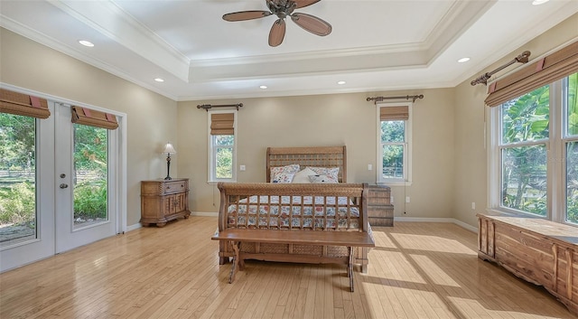 bedroom with multiple windows and light wood-type flooring