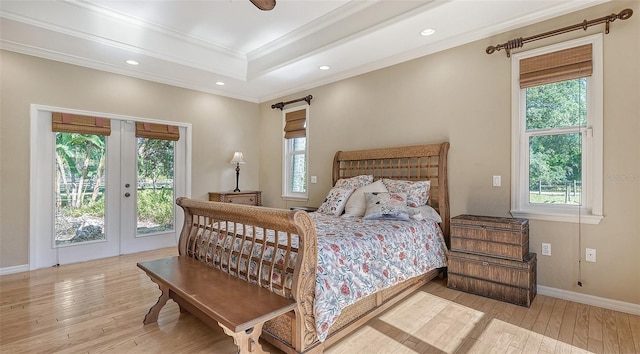 bedroom with light hardwood / wood-style flooring and multiple windows