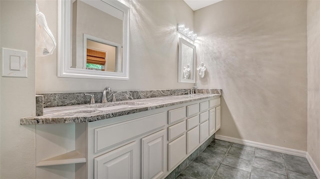 bathroom with oversized vanity, tile floors, and double sink