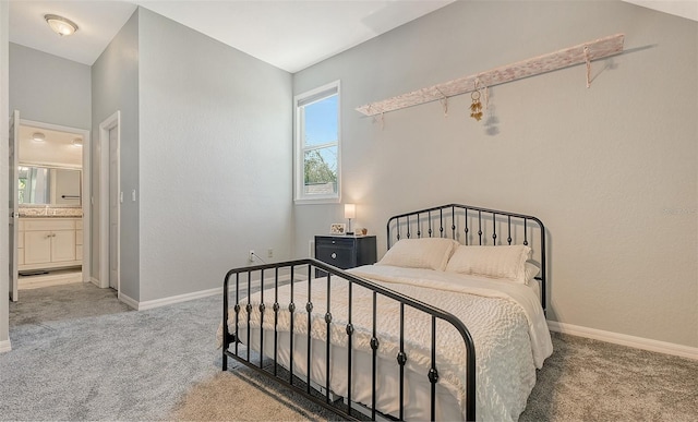 bedroom with light carpet and ensuite bathroom